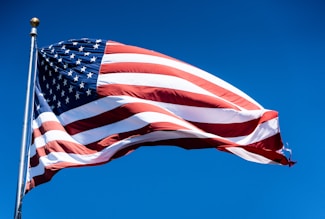 us a flag under blue sky during daytime