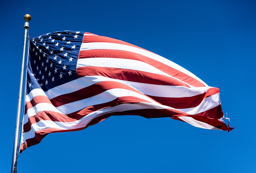 us a flag under blue sky during daytime