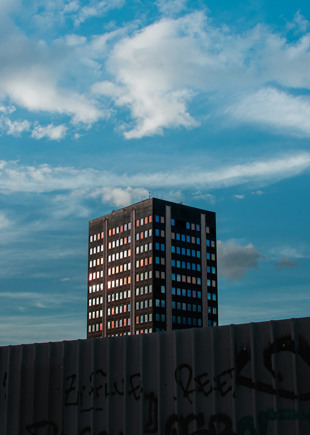 black and brown concrete building under blue sky