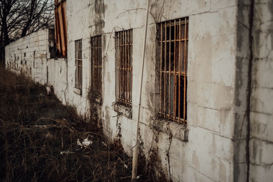 white concrete building with brown wooden window,