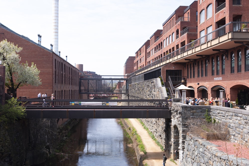 brown concrete building near bridge during daytime