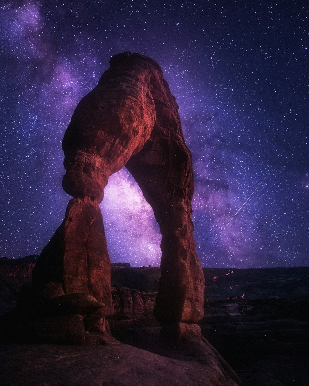 brown rock formation under starry night