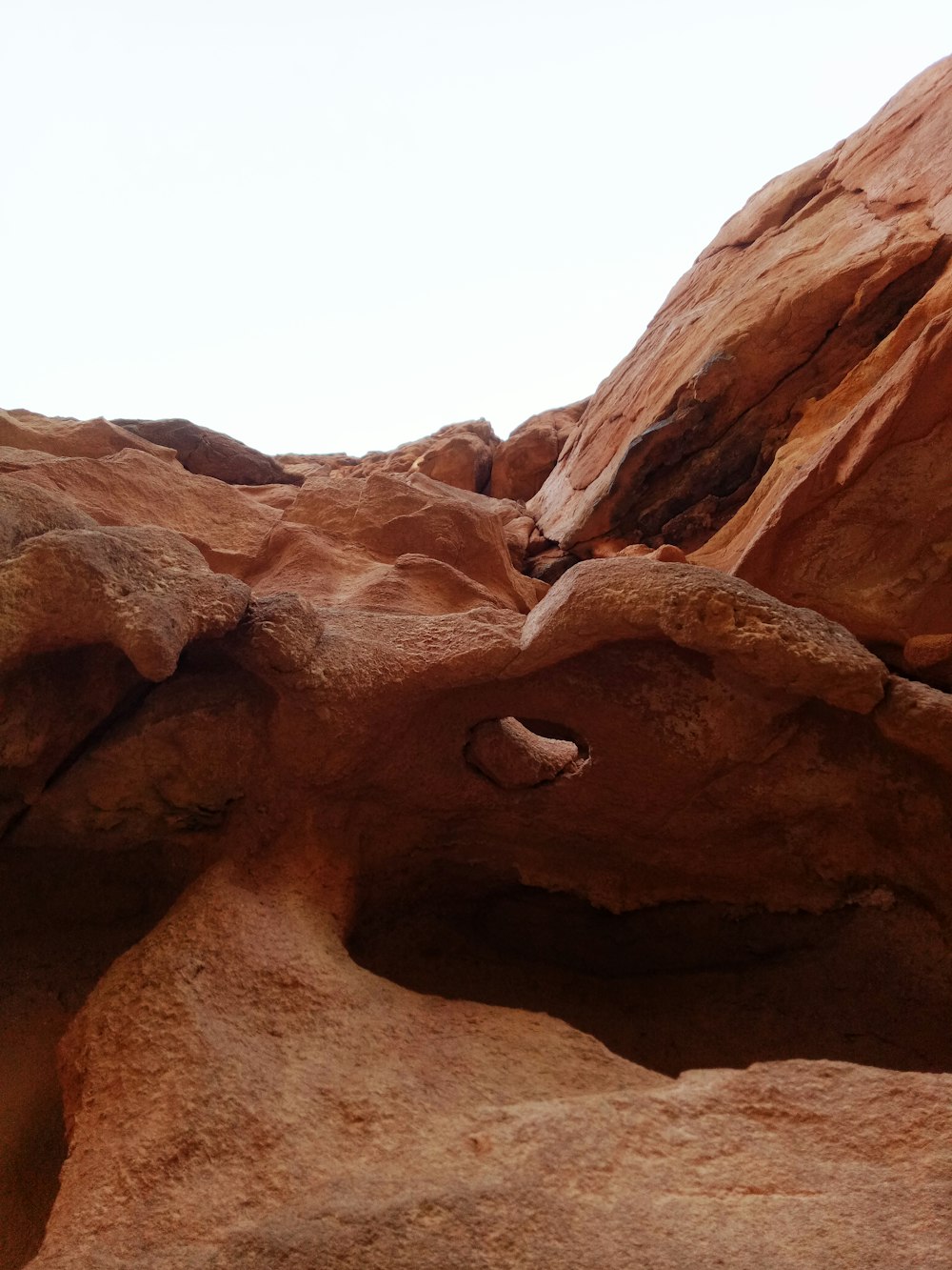 brown rock formation under white sky during daytime