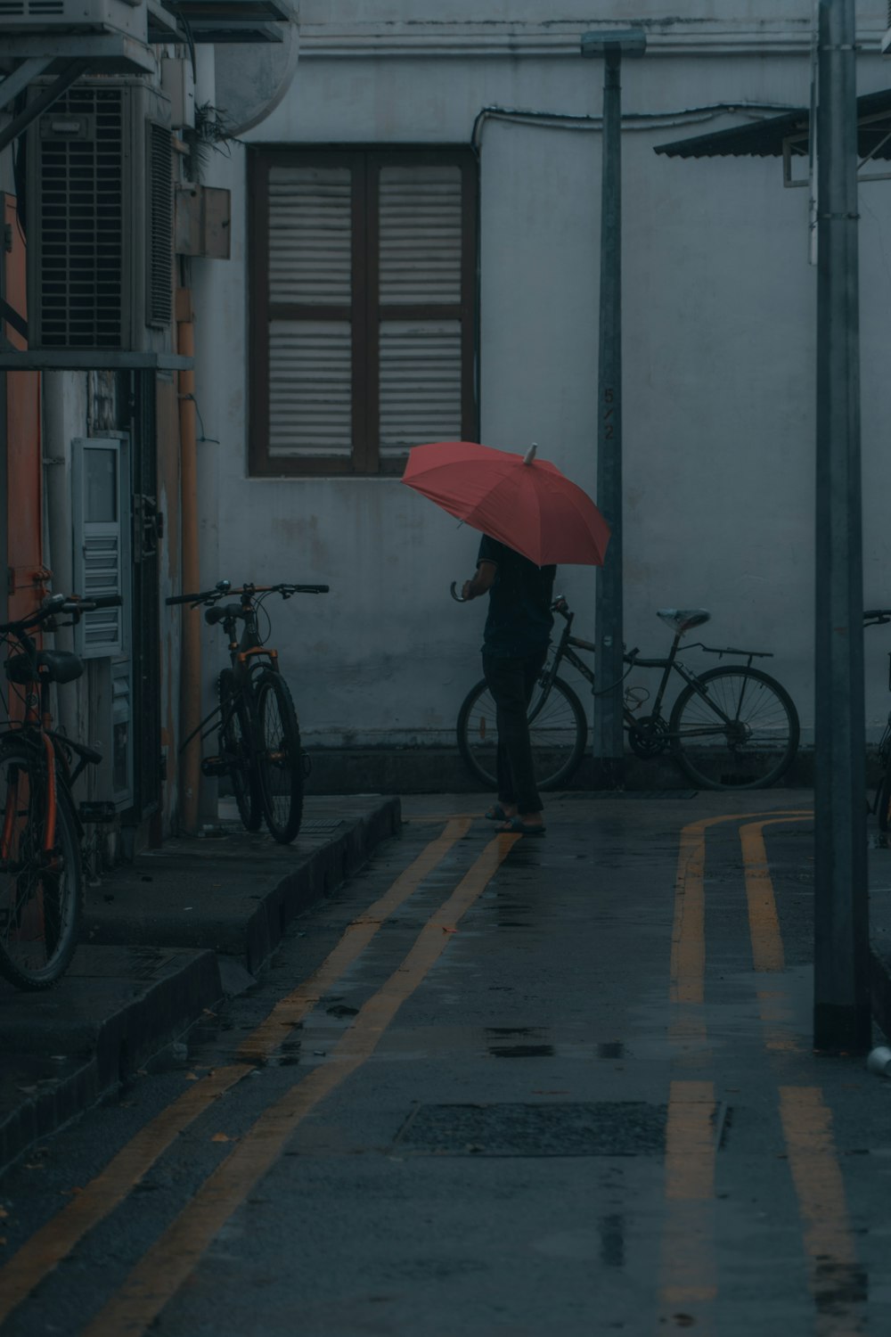 red umbrella on gray concrete floor