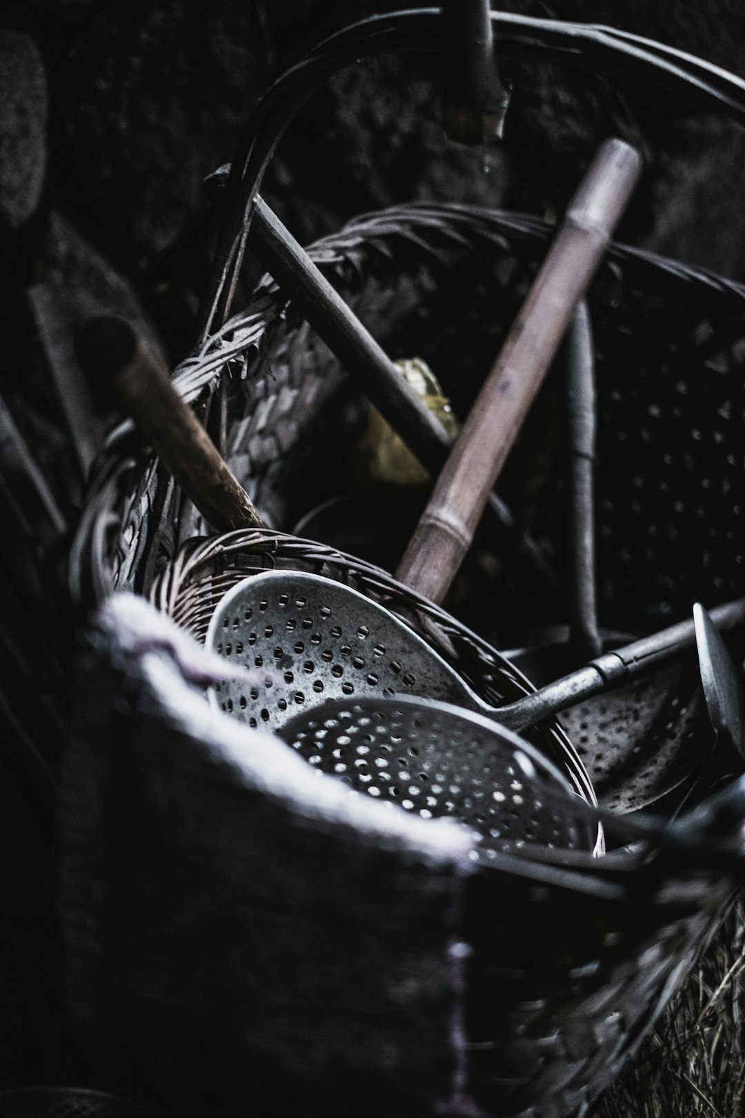 stainless steel spoons in black steel basket
