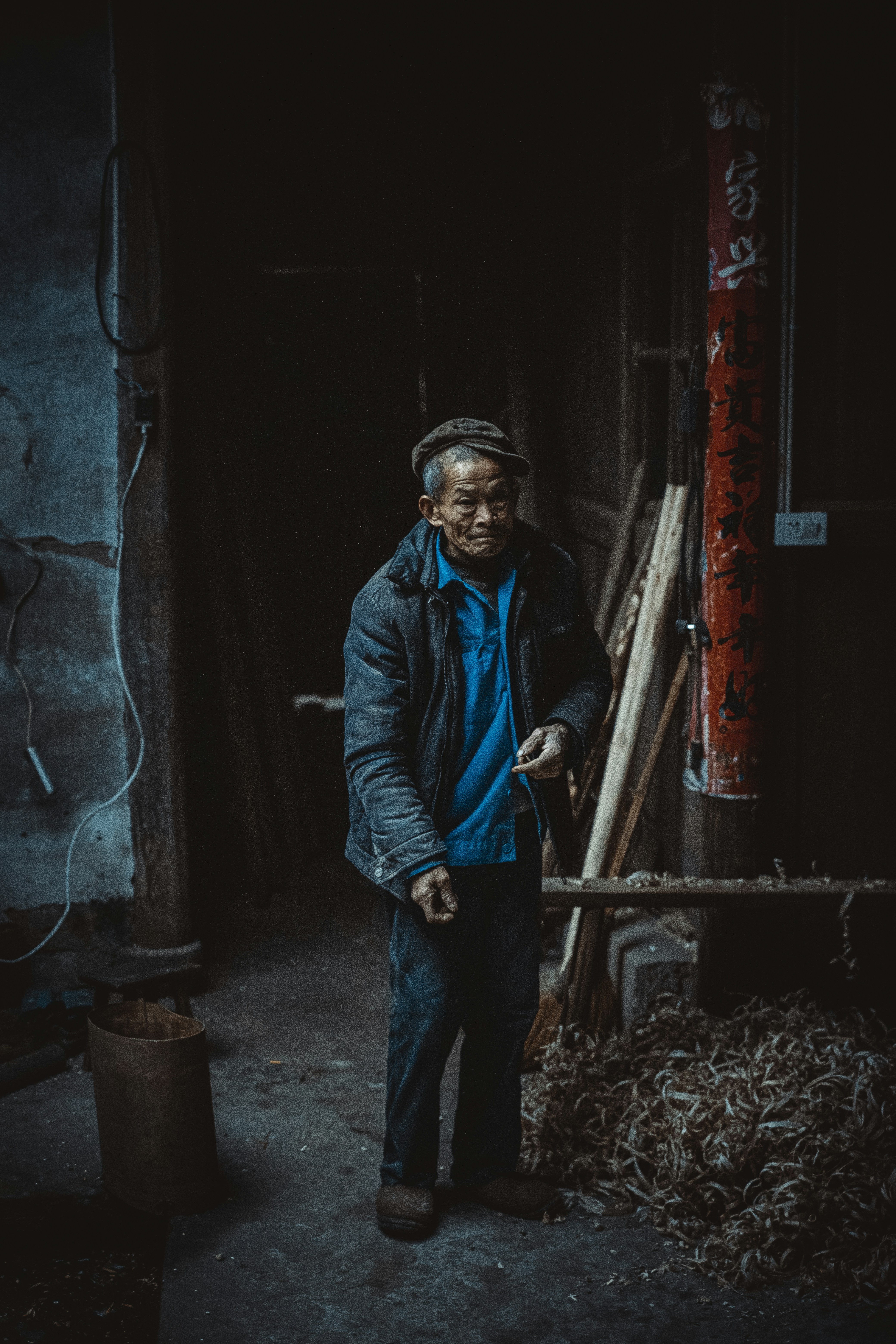 Man in blue jacket standing beside wall photo – Free Grey Image on Unsplash