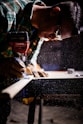 person holding orange and black power tool