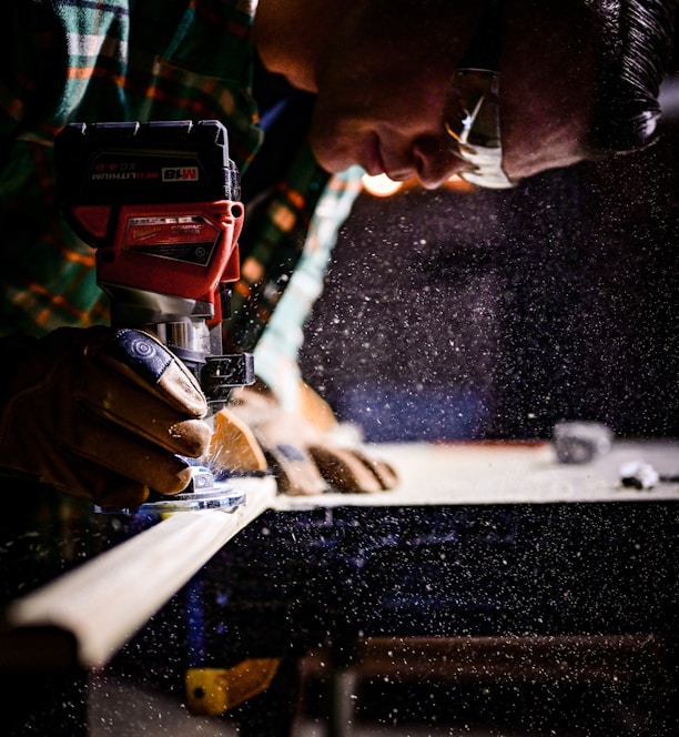 person holding orange and black power tool