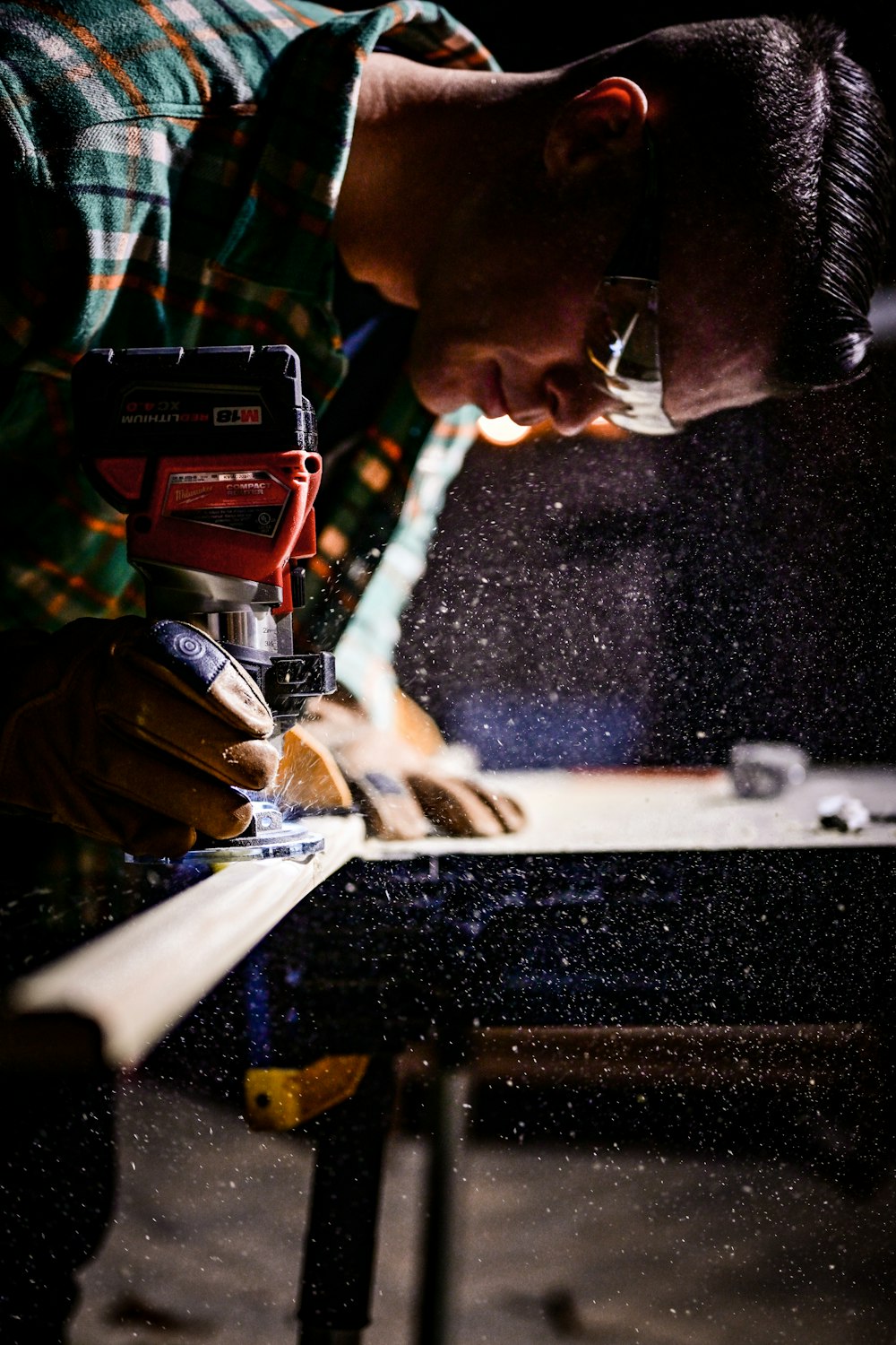 person holding orange and black power tool