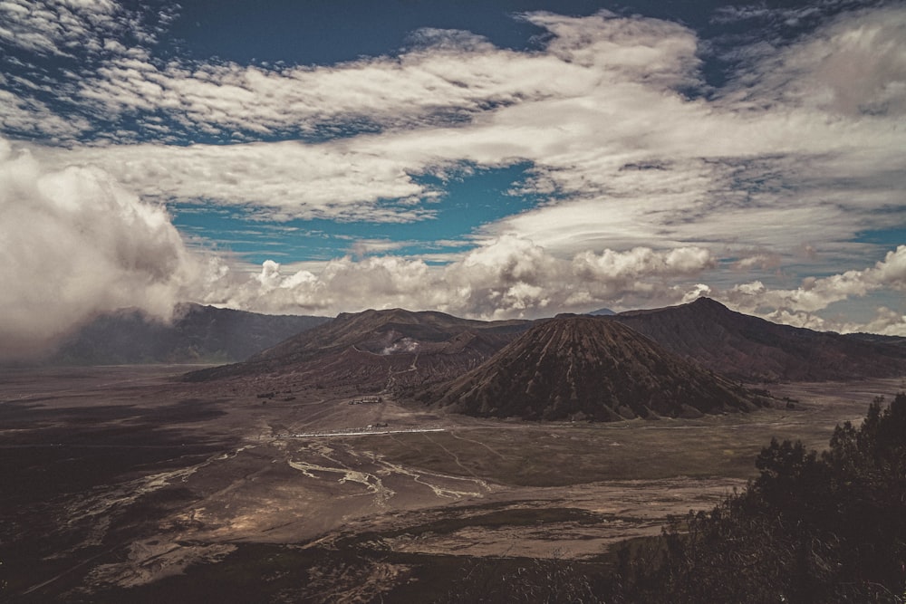 brown and green mountain under blue sky and white clouds during daytime