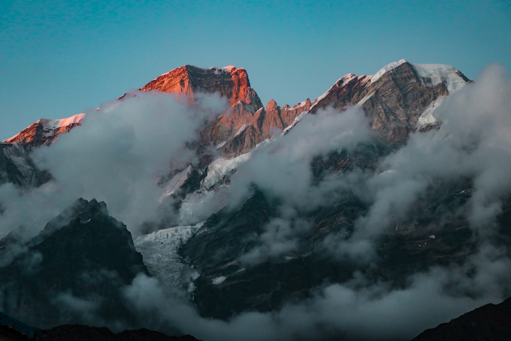 brown and white mountain under white clouds during daytime