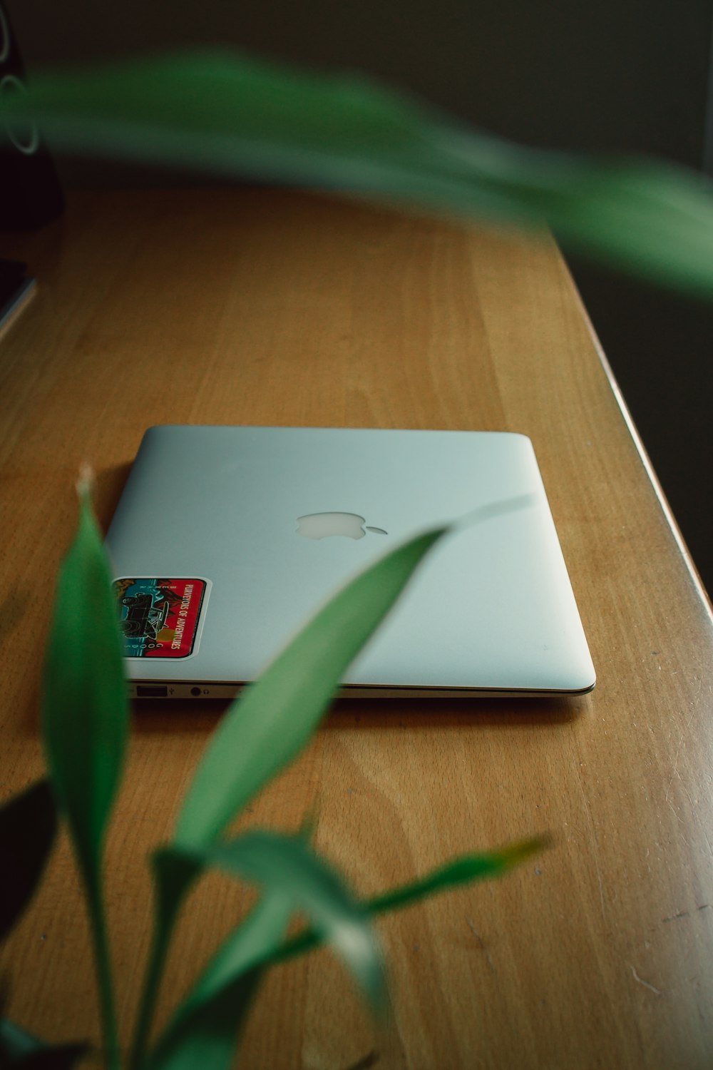 silver macbook on brown wooden table