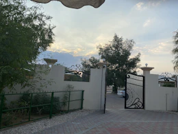Modern automatic gate opening smoothly at sunset with security lighting.