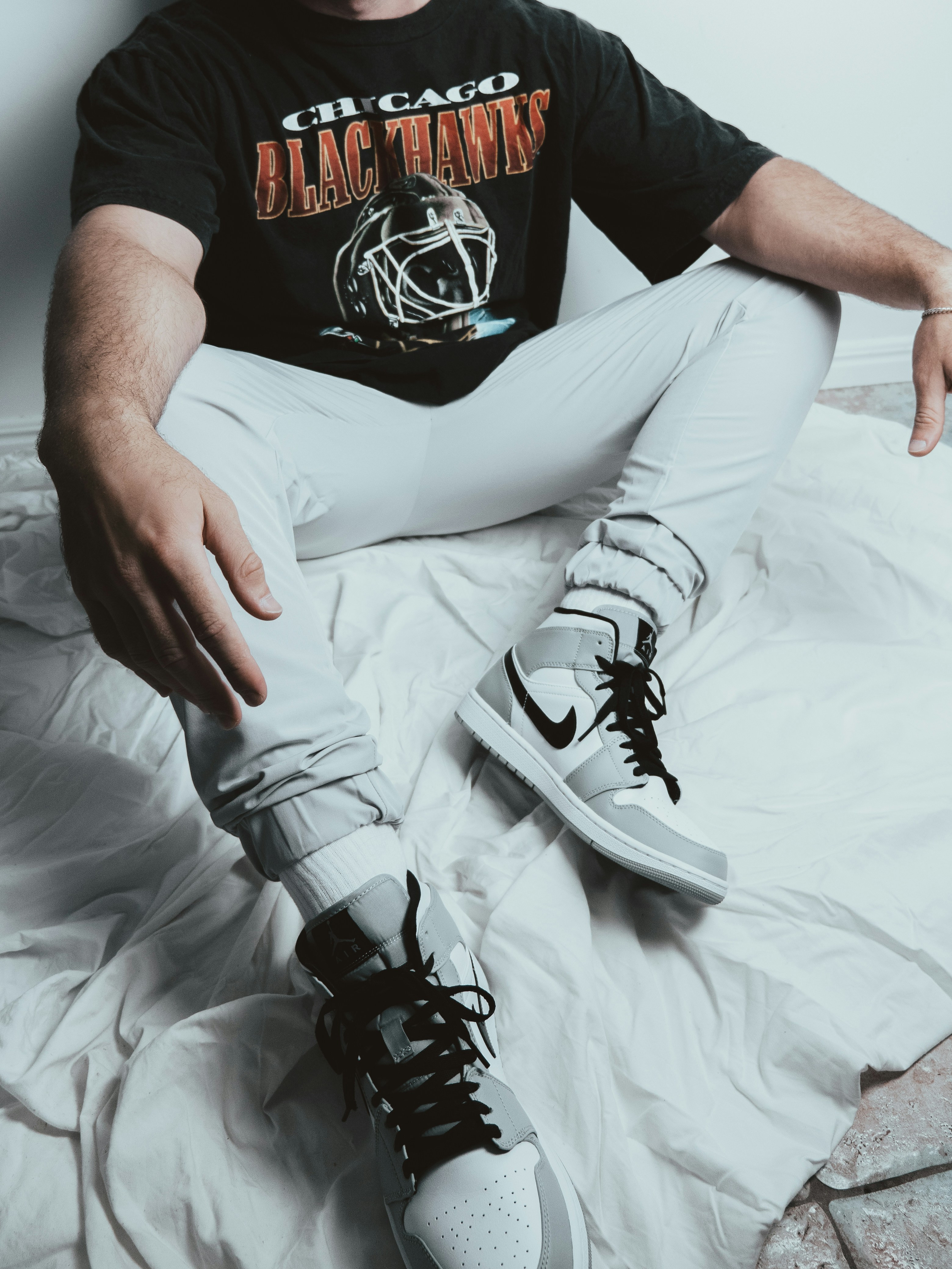 person in white pants wearing white nike sneakers