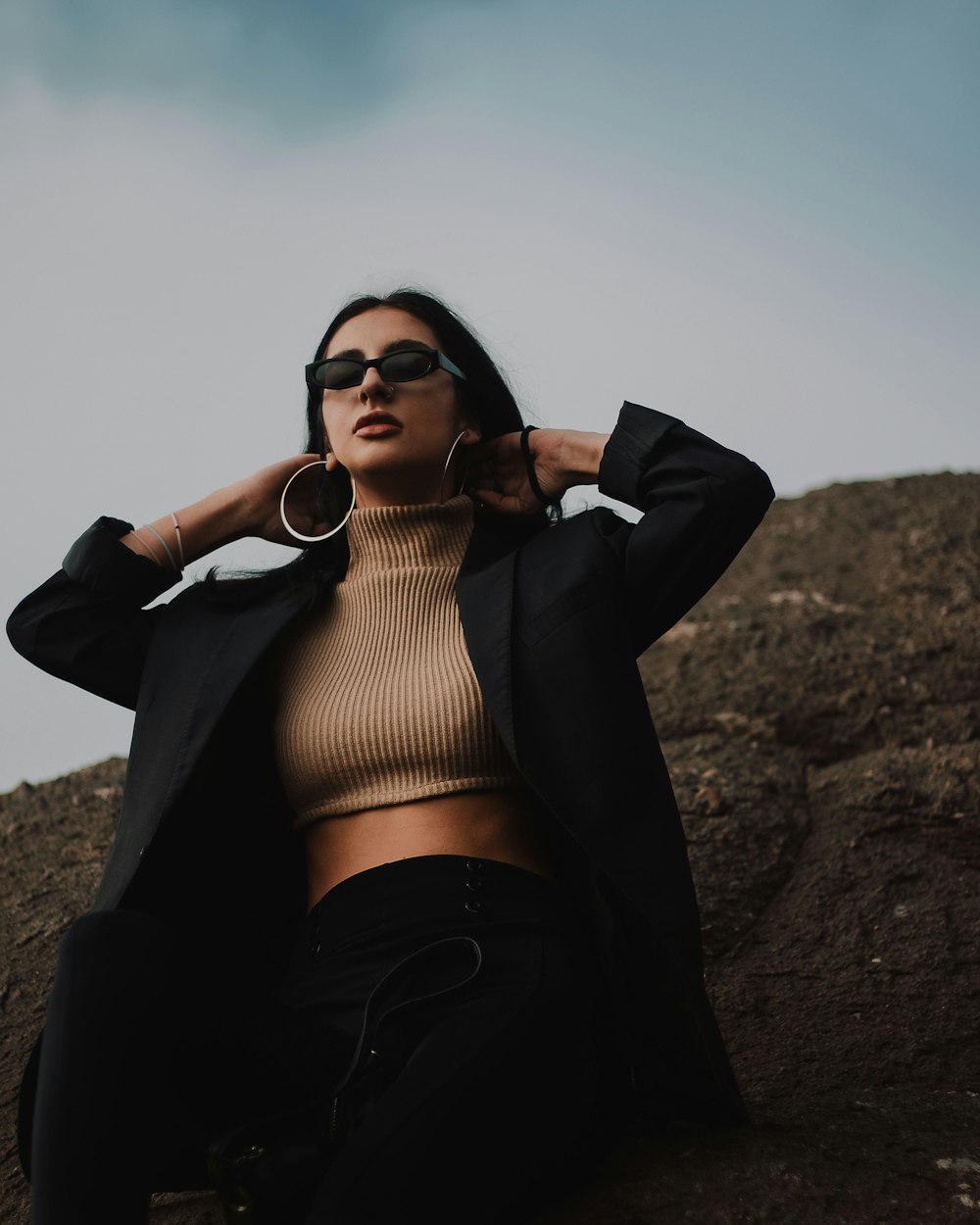 woman in black long sleeve crop top and black pants wearing black sunglasses