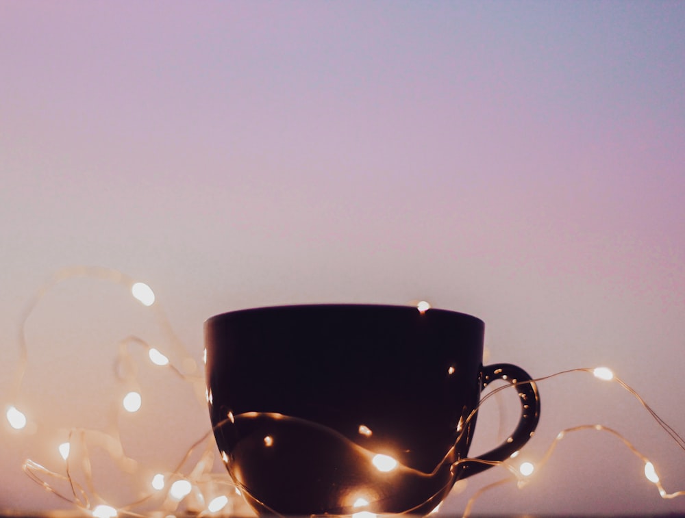 black ceramic mug with water droplets