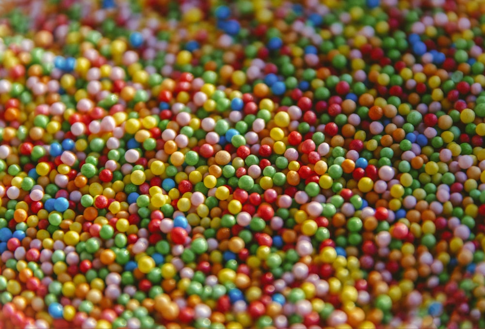 multi colored round beads on white surface