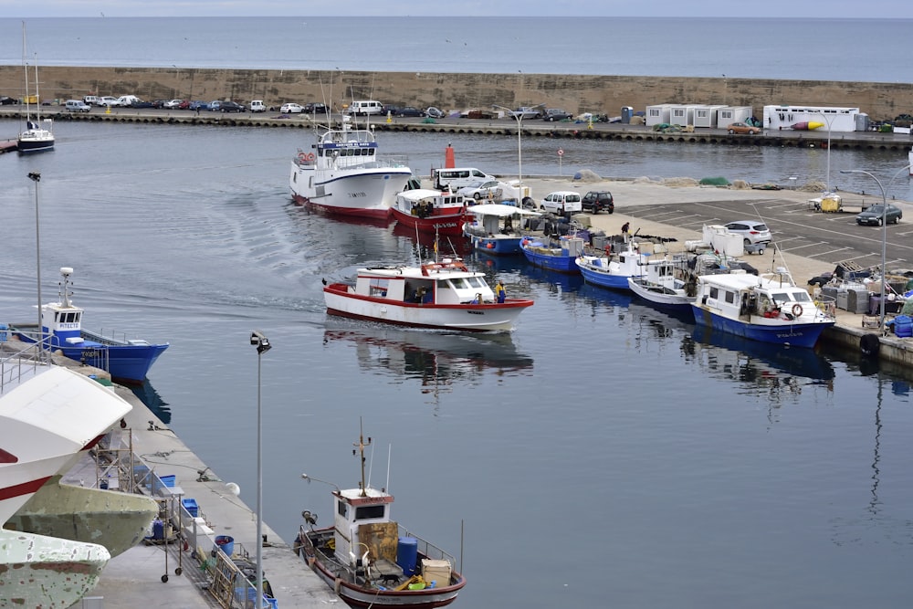 white and red boat on water during daytime