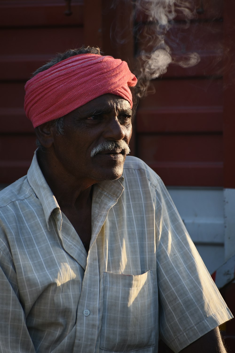 man in blue and white plaid button up shirt wearing red knit cap