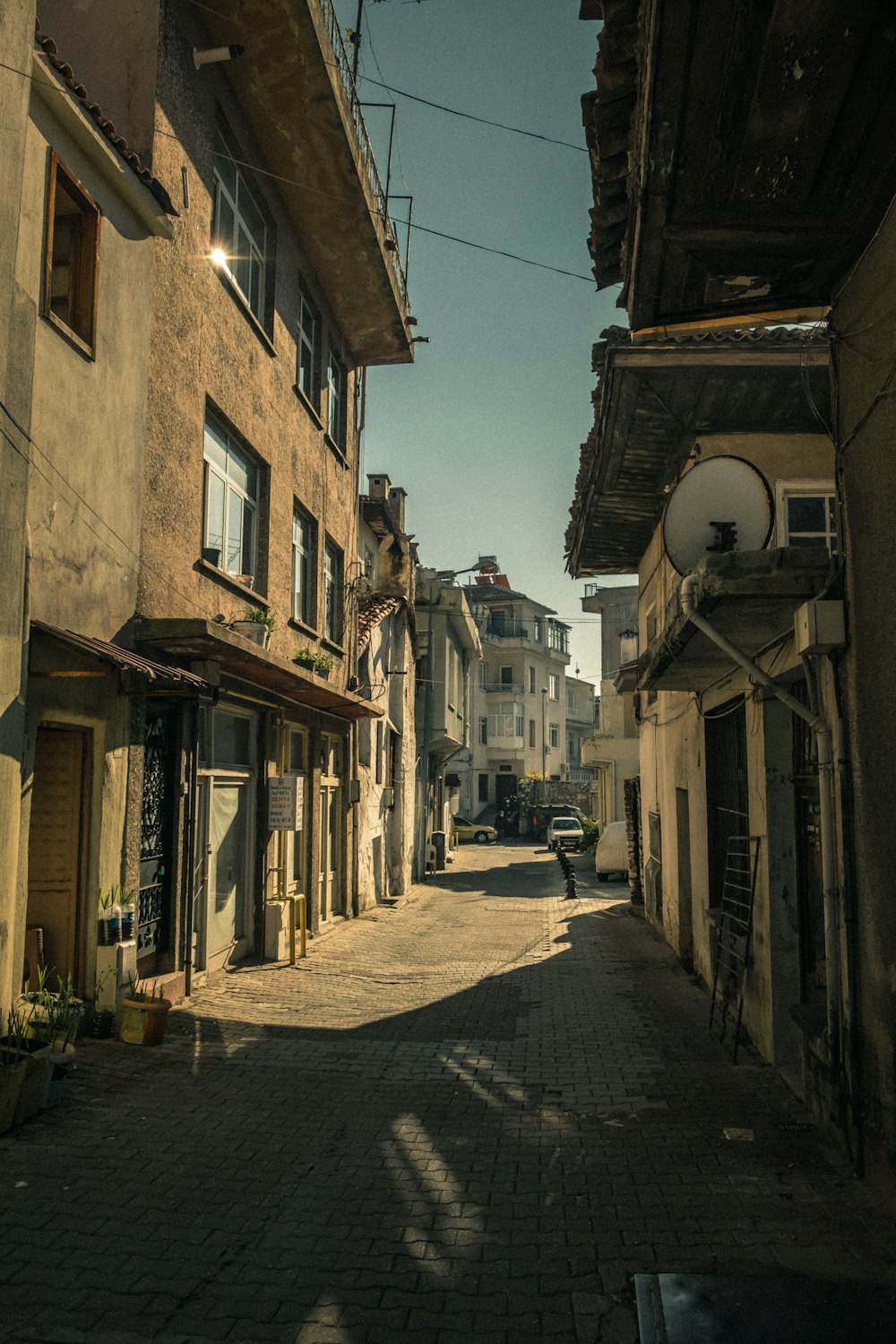 empty street between concrete buildings during daytime