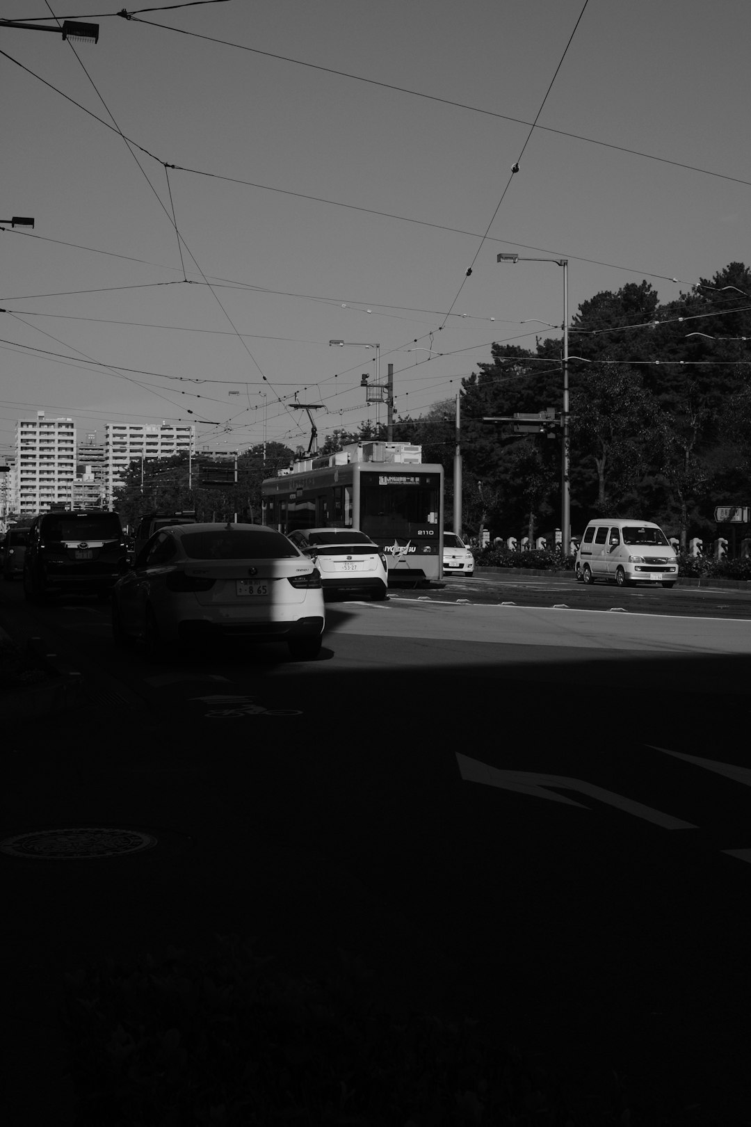 grayscale photo of cars on road