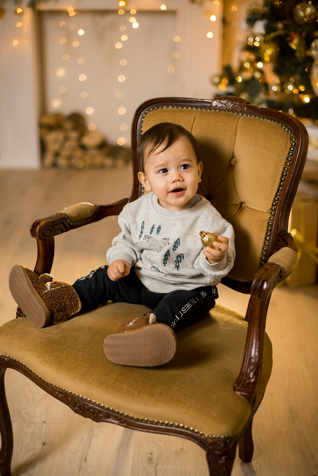 girl in white long sleeve shirt sitting on brown wooden armchair