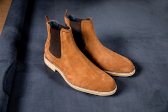 Side view of a rich brown Chelsea boot with elastic side panels and a sturdy sole.
