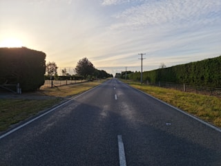 gray asphalt road under blue sky during daytime
