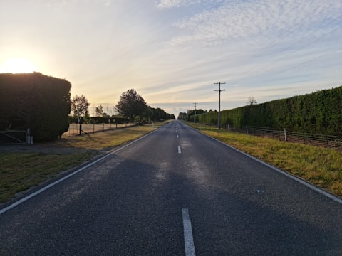 gray asphalt road under blue sky during daytime