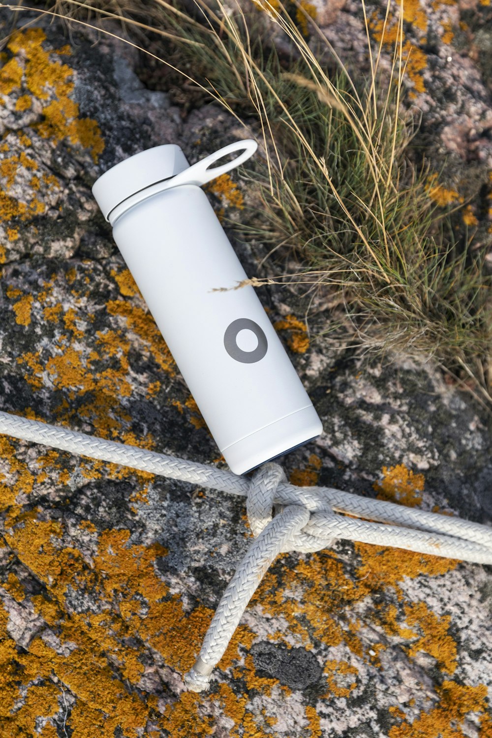 white and black plastic bottle on brown and black marble table