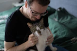 Foster family warmly welcoming a rescued cat into their home.