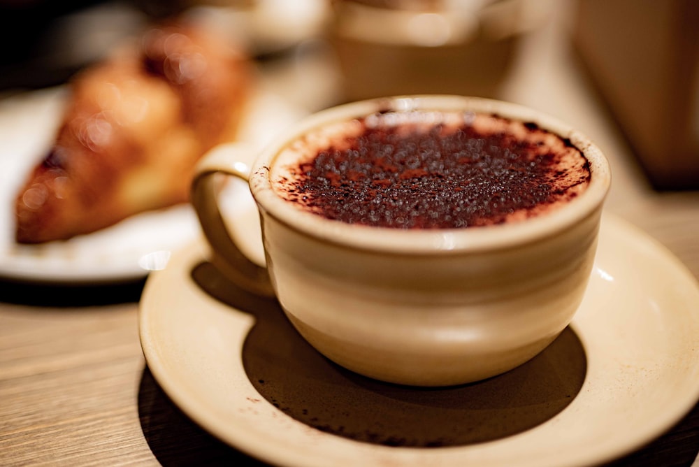 white ceramic cup with brown liquid