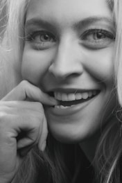 smiling woman with her hand on her chin