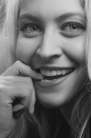 smiling woman with her hand on her chin