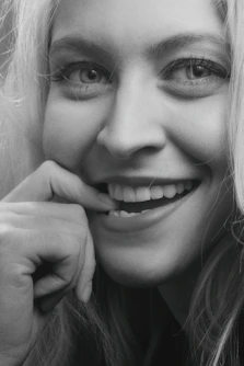 smiling woman with her hand on her chin
