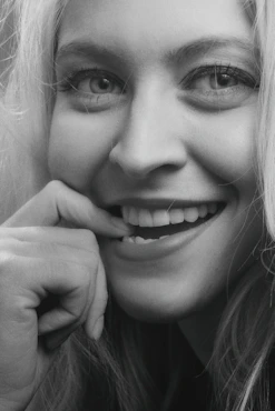 smiling woman with her hand on her chin