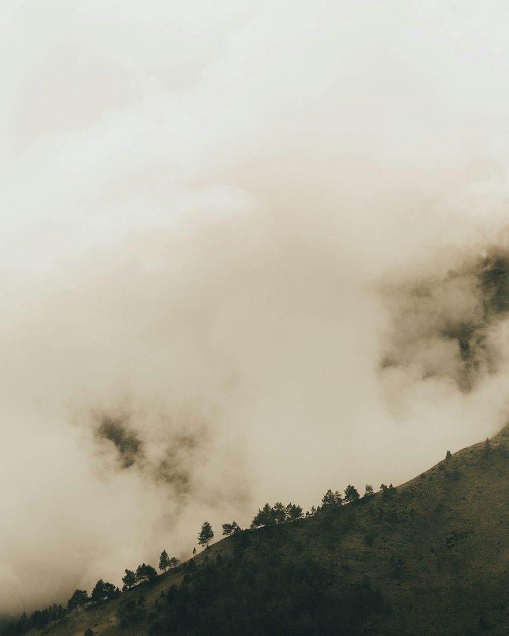 green mountain under white clouds