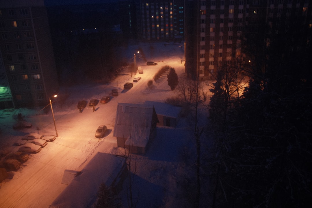 snow covered field near building during night time