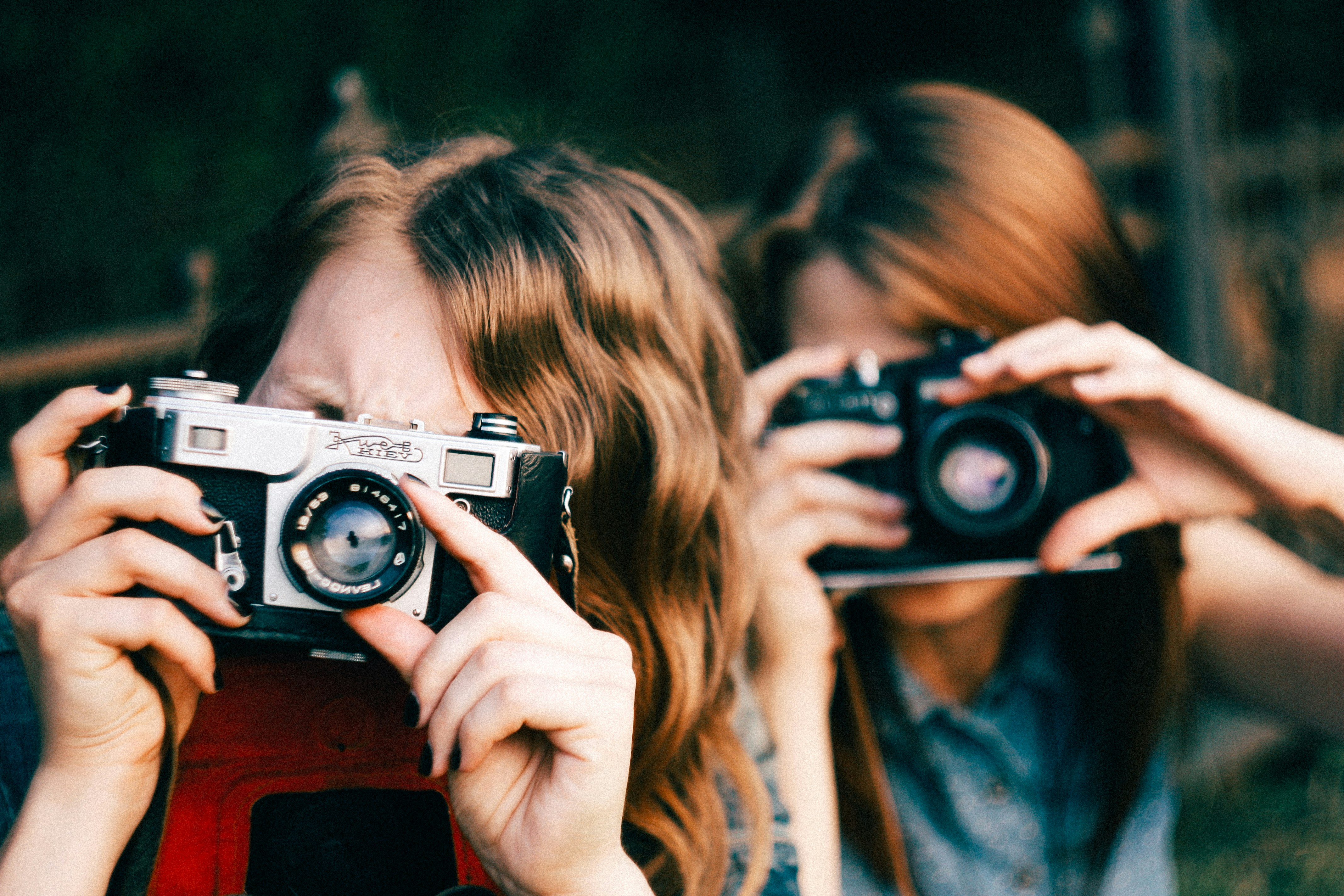 woman holding black and silver camera