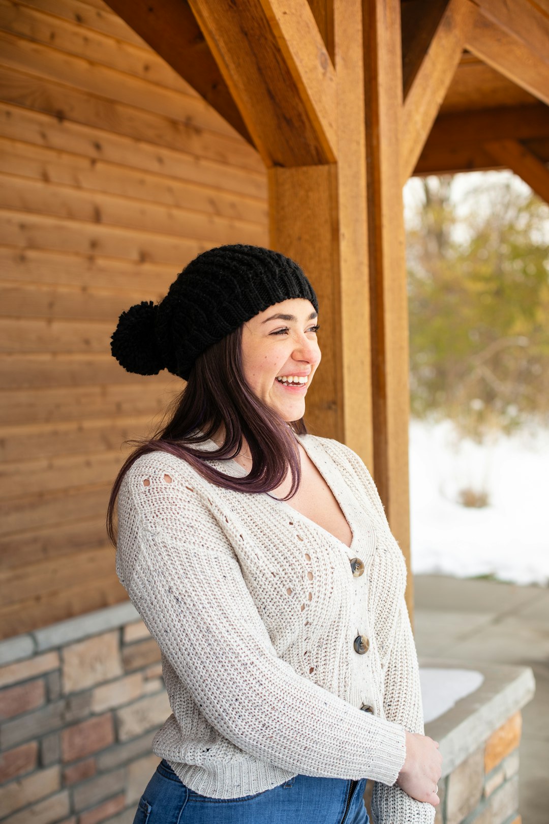 woman in white knit sweater and black knit cap