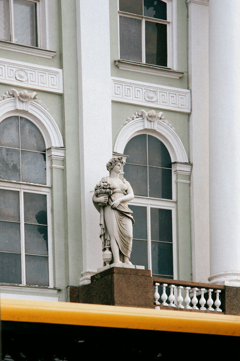 white concrete building with statue of man