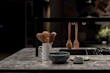 Close-up of modern kitchen utensils and gadgets on a wooden countertop