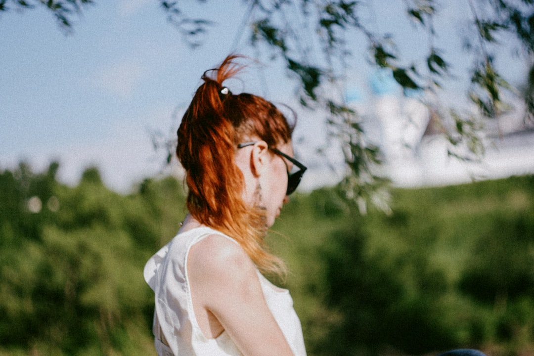 woman in white tank top wearing black sunglasses