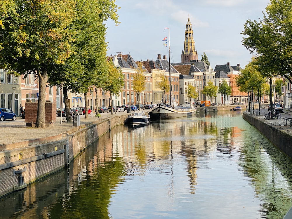 Boot auf dem Fluss in der Nähe von Bäumen und Gebäuden tagsüber