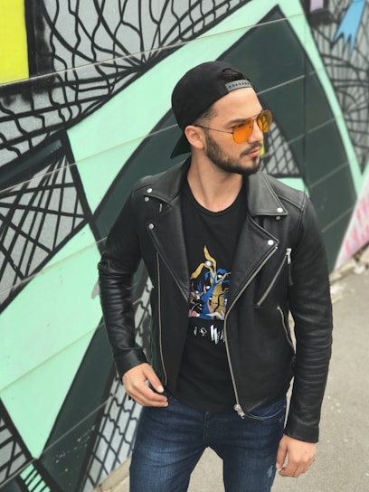 A sleek black jacket displayed against a vibrant city mural reflecting urban energy.