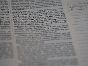 A close-up view of a page from a book, featuring clearly printed text on the left and faint handwritten notes on the right. The text discusses historical events and figures. The page is accompanied by lined sections for annotations.