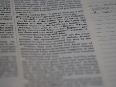 A close-up view of a page from a book, featuring clearly printed text on the left and faint handwritten notes on the right. The text discusses historical events and figures. The page is accompanied by lined sections for annotations.