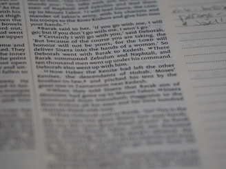 A close-up view of a page from a book, featuring clearly printed text on the left and faint handwritten notes on the right. The text discusses historical events and figures. The page is accompanied by lined sections for annotations.