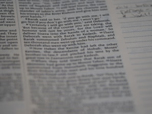 A close-up view of a page from a book, featuring clearly printed text on the left and faint handwritten notes on the right. The text discusses historical events and figures. The page is accompanied by lined sections for annotations.