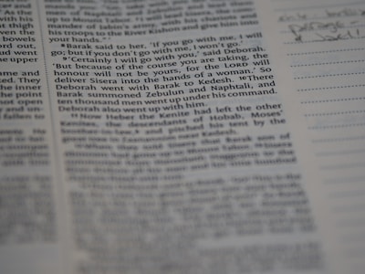 A close-up view of a page from a book, featuring clearly printed text on the left and faint handwritten notes on the right. The text discusses historical events and figures. The page is accompanied by lined sections for annotations.